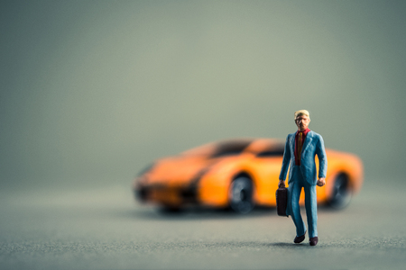 Miniature businessman and luxury carの写真素材