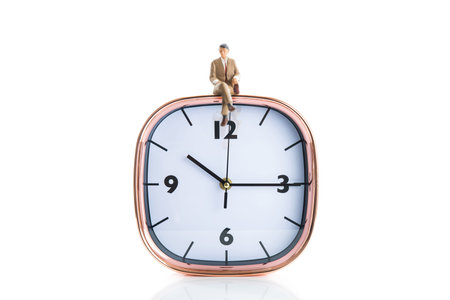 Businessman sitting on the clockの写真素材