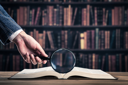 Books and magnifying glassの写真素材