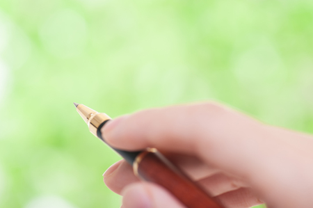 Ballpoint pen green backgroundの写真素材