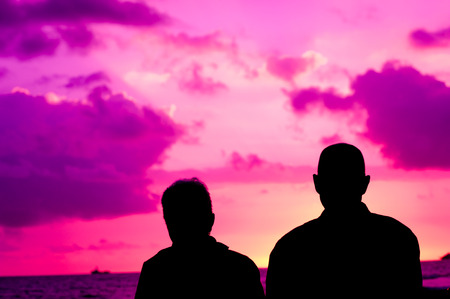 Senior couple stare at sunsetの写真素材
