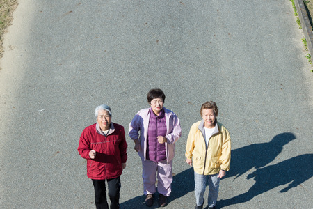 Three Japanese elderly to walk the roadの写真素材