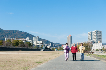 Three Japanese elderly to walk the roadの写真素材