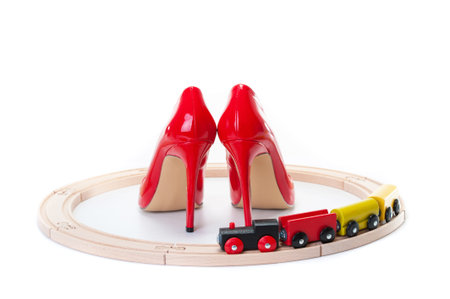 Red high heels and a toy locomotiveの写真素材