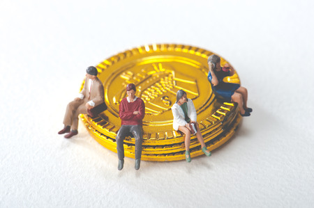 People are sitting on gold coinの写真素材