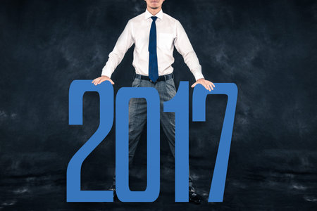 Businessman standing on a dark background