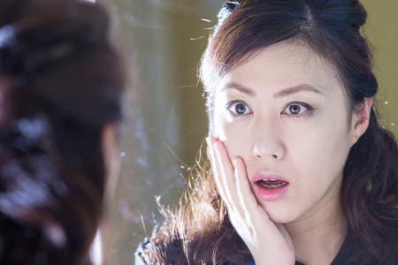 Women who are reflected in the mirrorの写真素材