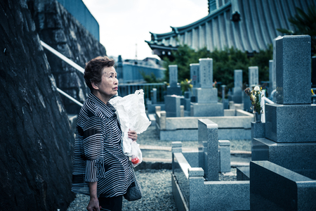 Japanese women of the elderly that visit the graveの写真素材