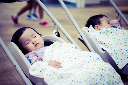 Baby sleeping in a strollerの写真素材