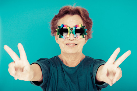 elderly woman blue backgroundの写真素材