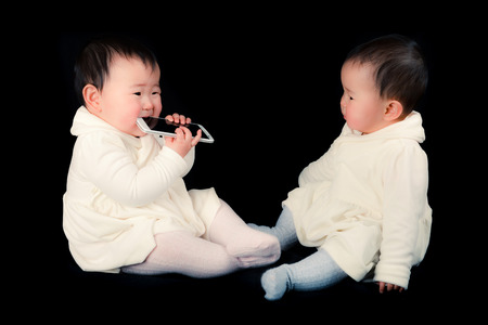 Baby and smart phoneの写真素材