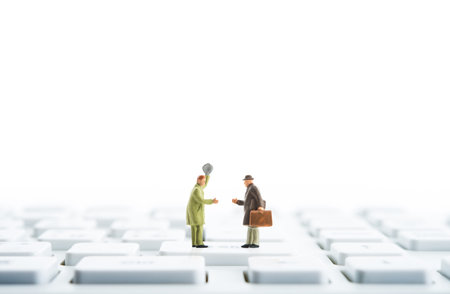 Miniature businessmen shake handsの写真素材