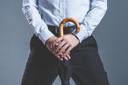man holding a black umbrellaの写真素材