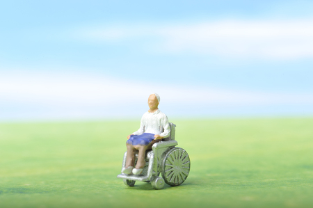 Miniature human with wheelchairの写真素材