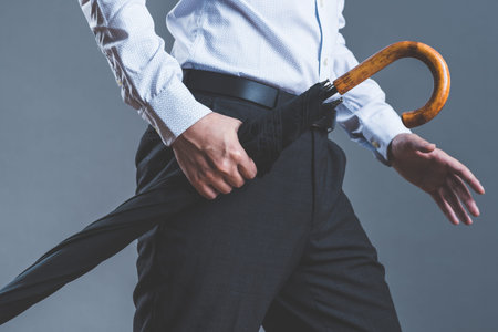 man holding a black umbrellaの写真素材