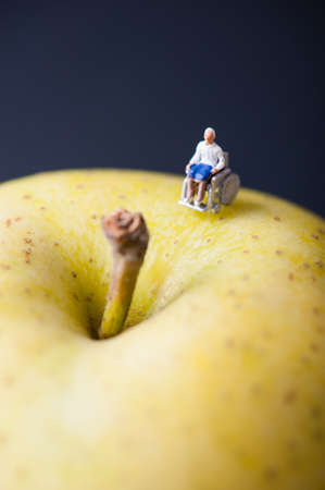 Miniature human with wheelchairの写真素材