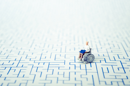 Miniature human with wheelchairの写真素材