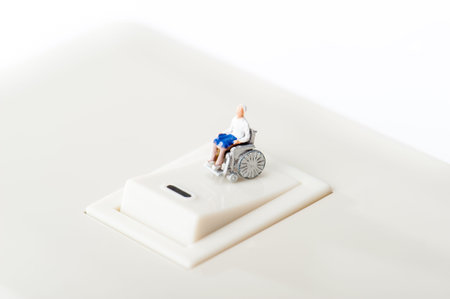 Miniature human with wheelchairの写真素材