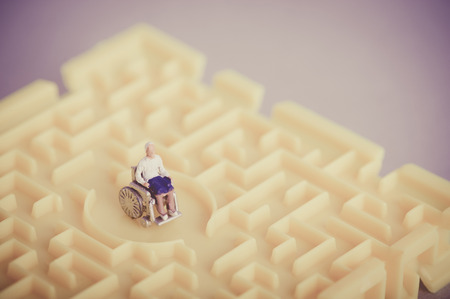 Miniature human with wheelchairの写真素材