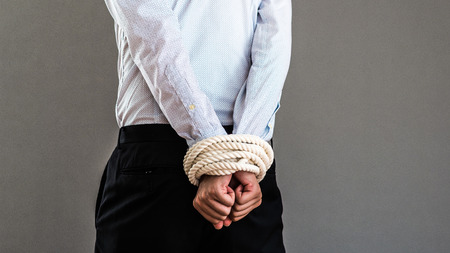 Businesspeople who are tied up with ropesの写真素材