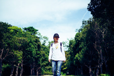 Japanese woman walking in natureの写真素材