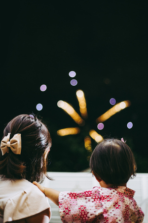 Child watching fireworksの写真素材