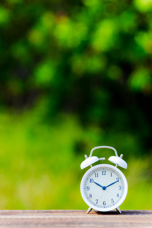 Alarm clock and green blur background