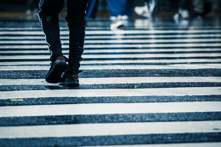 People across the crosswalk on a rainy dayの写真素材