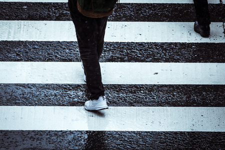 People across the crosswalk on a rainy dayの写真素材