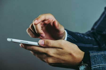 hands of men using mobile phonesの写真素材