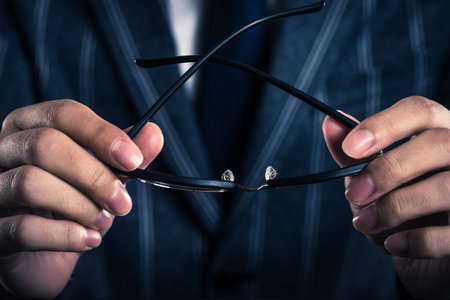 businessman holding glasses