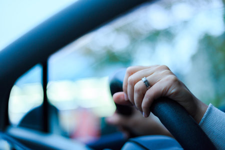 Close-up of a woman's hand holding a car handleの写真素材