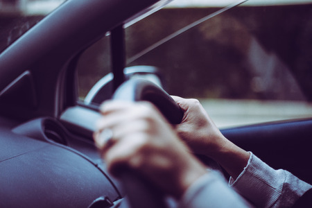 Close-up of a woman's hand holding a car handleの写真素材
