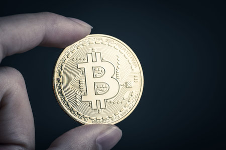 hand holding a bitcoinの写真素材