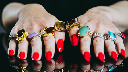 Women's hand with lots of  jewelry ringsの写真素材