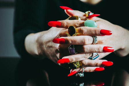 Women's hand with lots of  jewelry ringsの写真素材