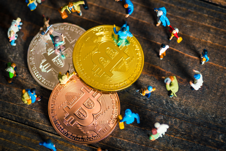 Miniature people with bit coinの写真素材