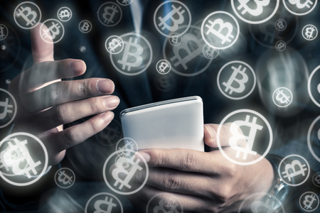 businessman operating a bit coin with a smartphoneの写真素材
