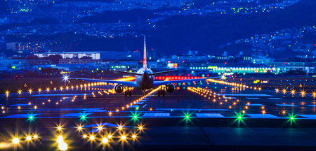 Passenger airplane landing in nightの写真素材