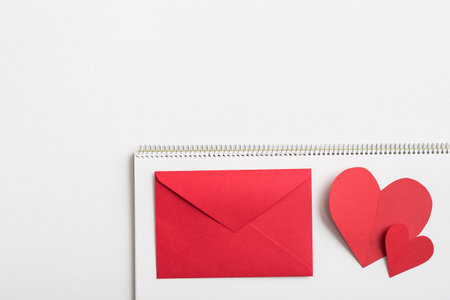 Red heart and love letter on the white sketchbook