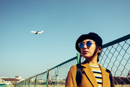 Asian woman and airplaneの写真素材