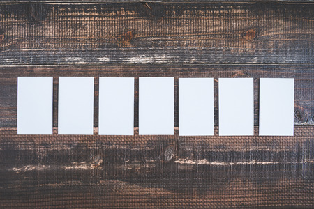 White card on a wooden deskの写真素材