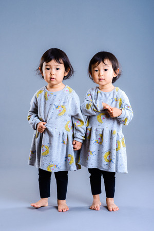 Cute twins children studio portraitの写真素材