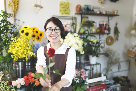 Asian women working in a flower shopの写真素材