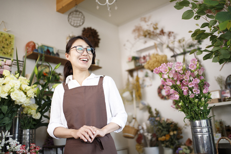 Asian women working in a flower shopの写真素材