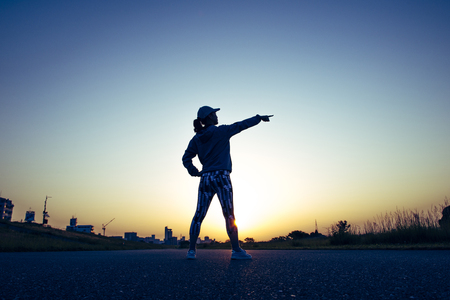 woman warming up with the morning sunの写真素材