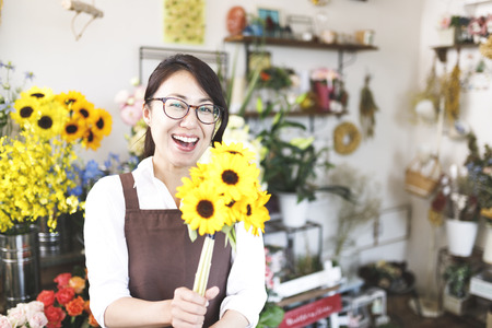 Asian women working in a flower shopの写真素材