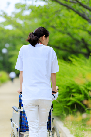 Elderly female wheelchair and caregiverの写真素材