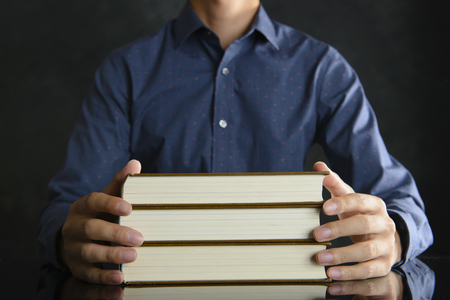 Heavy books and businessmenの写真素材