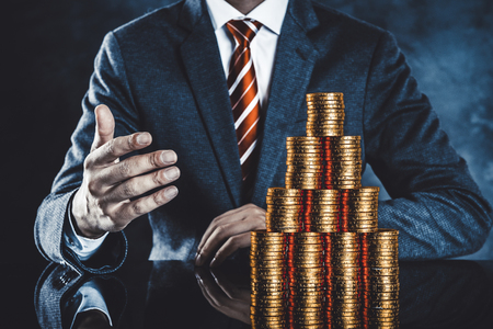 Lots of gold coins and businessmenの写真素材